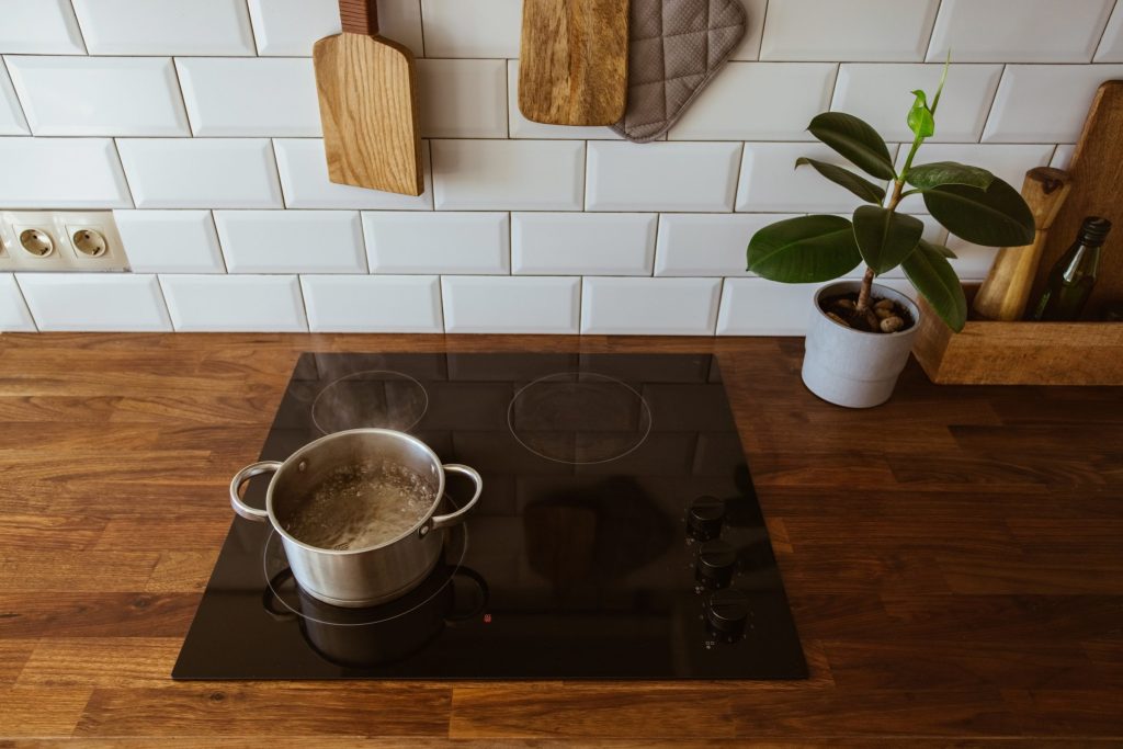 An oven in a boiling water on a kitchen counter.