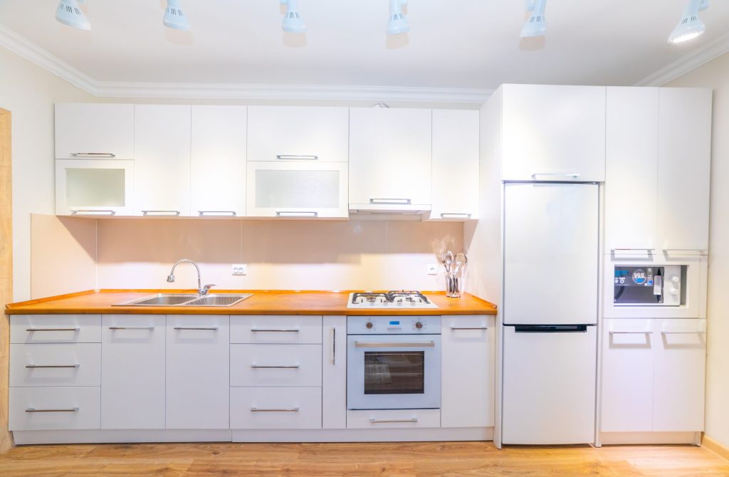 A range in a bright and clean white kitchen interior.