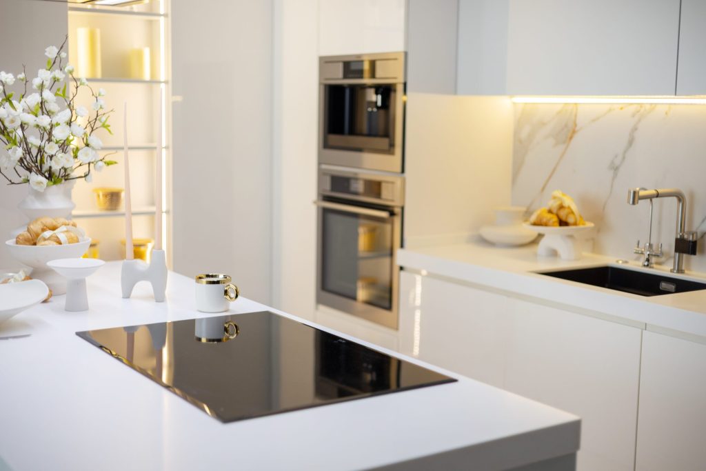 An oven in a bright kitchen interior with marble.