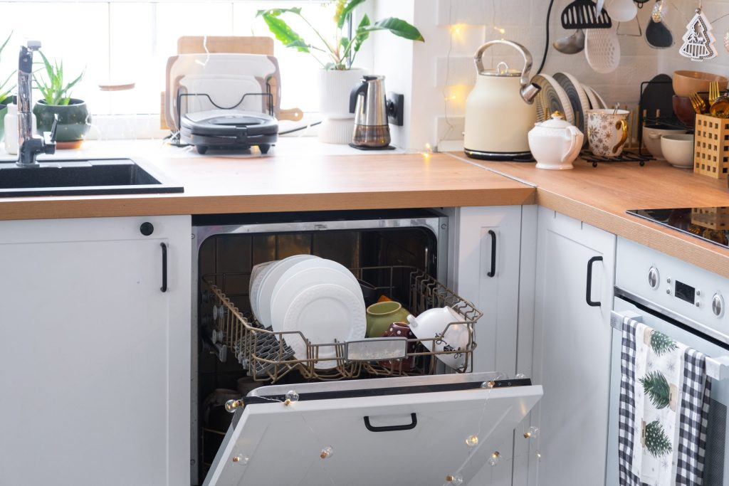 Clean dishes in open dishwasher.