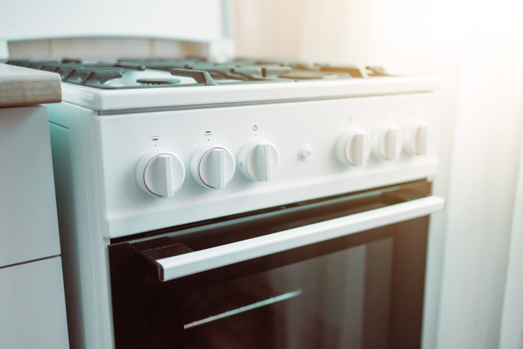 Close up of stylish new white gas stove.