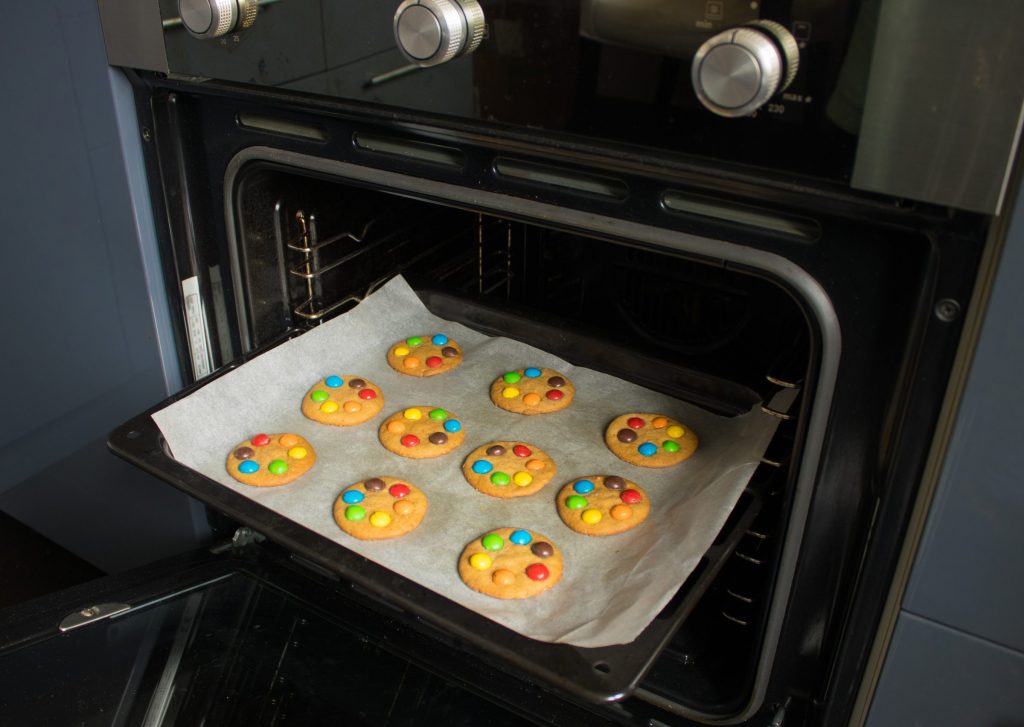 Cookies baking in an oven at home.