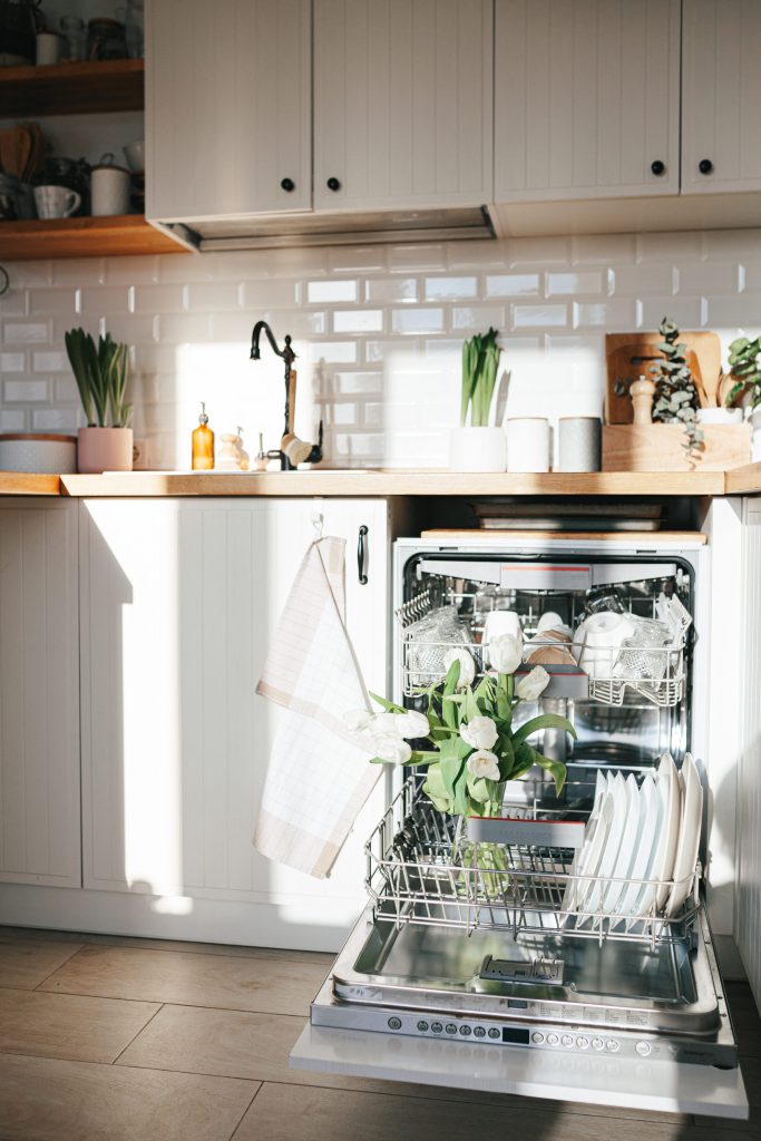 Dishwasher open in a tidy well lit.