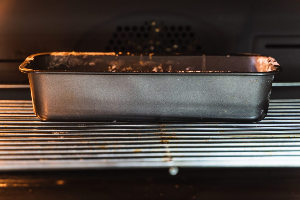 Empty baking pan inside of an oven.