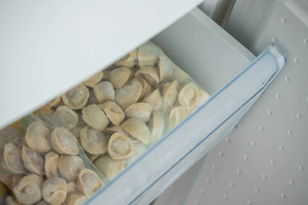 Frozen dumplings in a freezer drawer.
