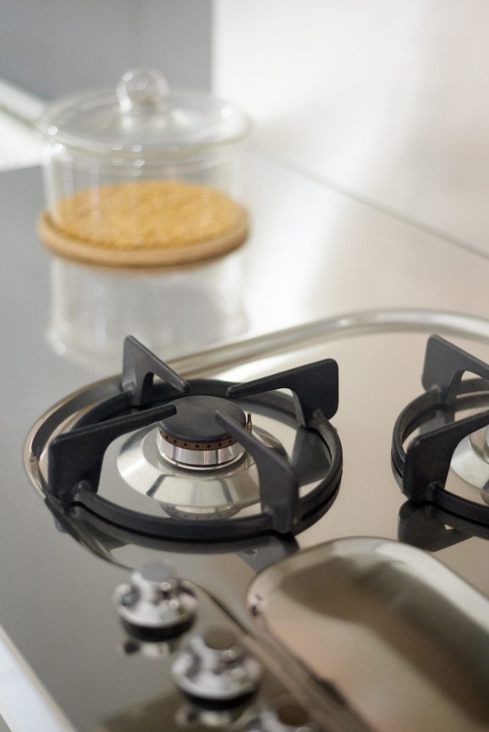 Gas stove top with storage jar.