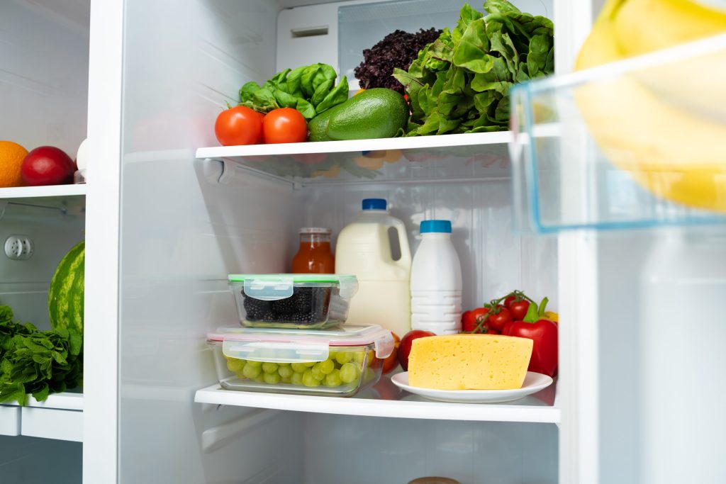 Healthy food in a refrigerator with fresh produce.