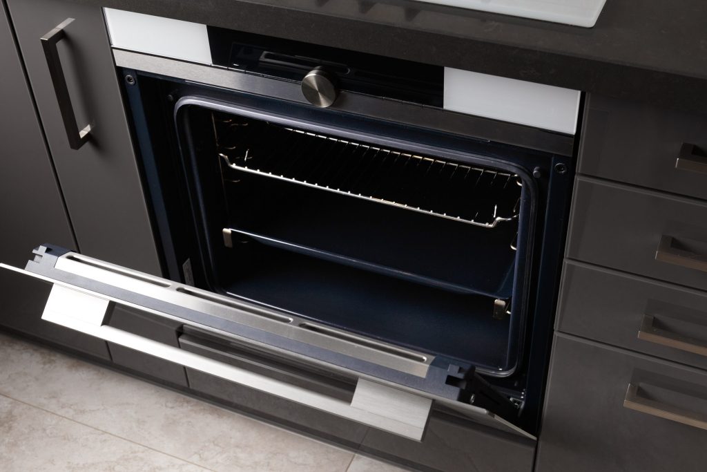 Modern kitchen appliance design with gray cabinets.