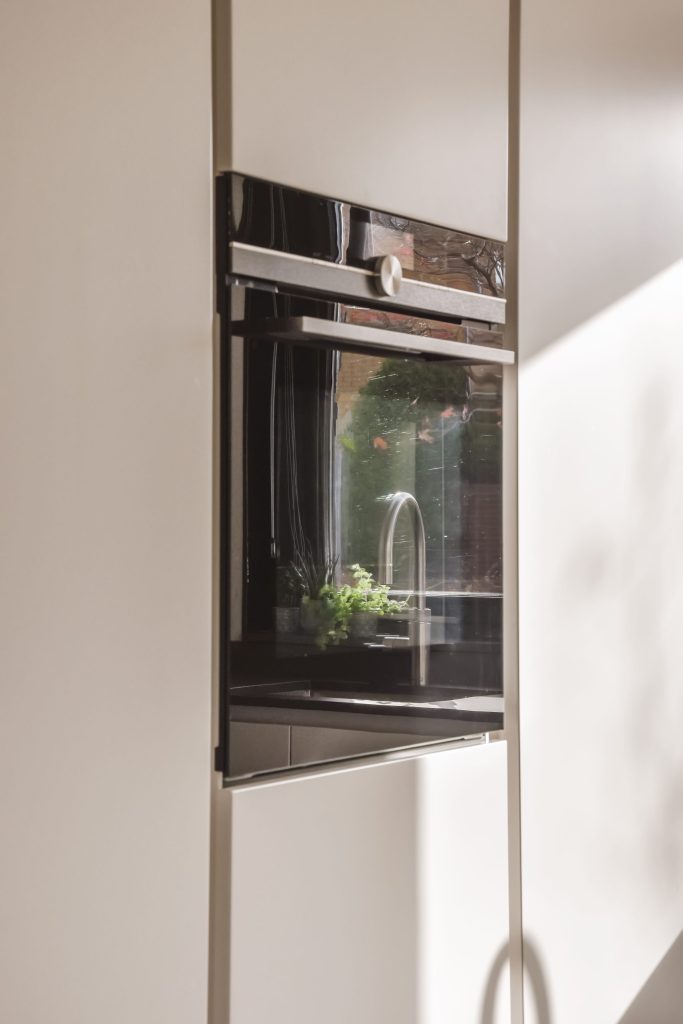 Modern kitchen oven with reflective door.