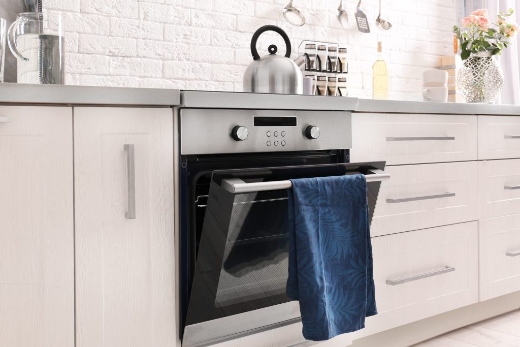 Modern kitchen with stainless steel oven.
