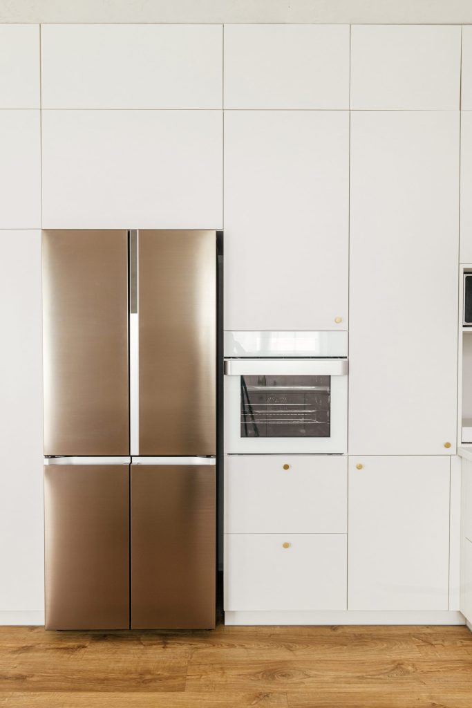Modern kitchen with stainless steel refrigerator.