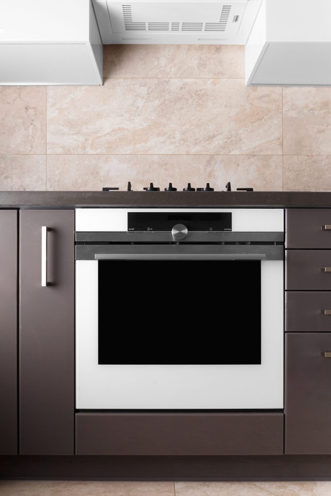Modern oven and cooktop in neutral.