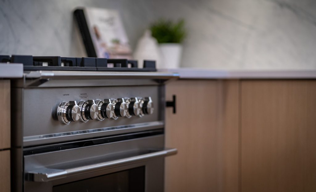Modern stainless steel gas range in home.