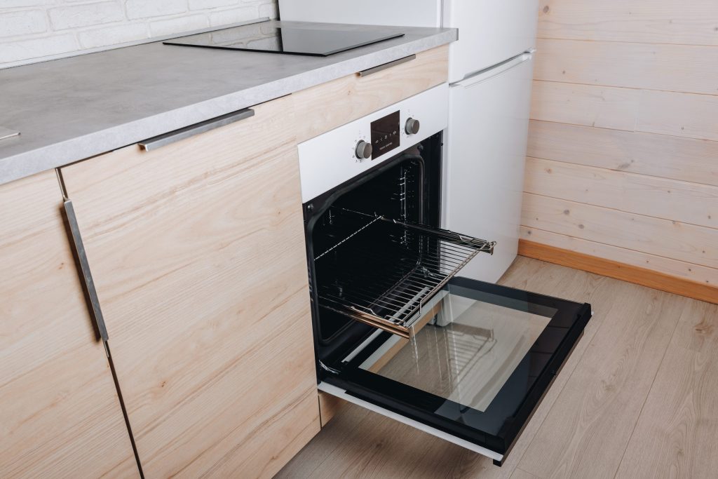 Modern white oven with open door.