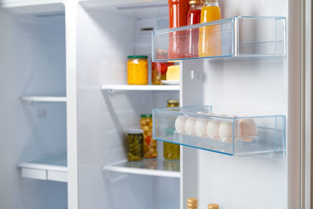 Neat refrigerator interior with various jars.