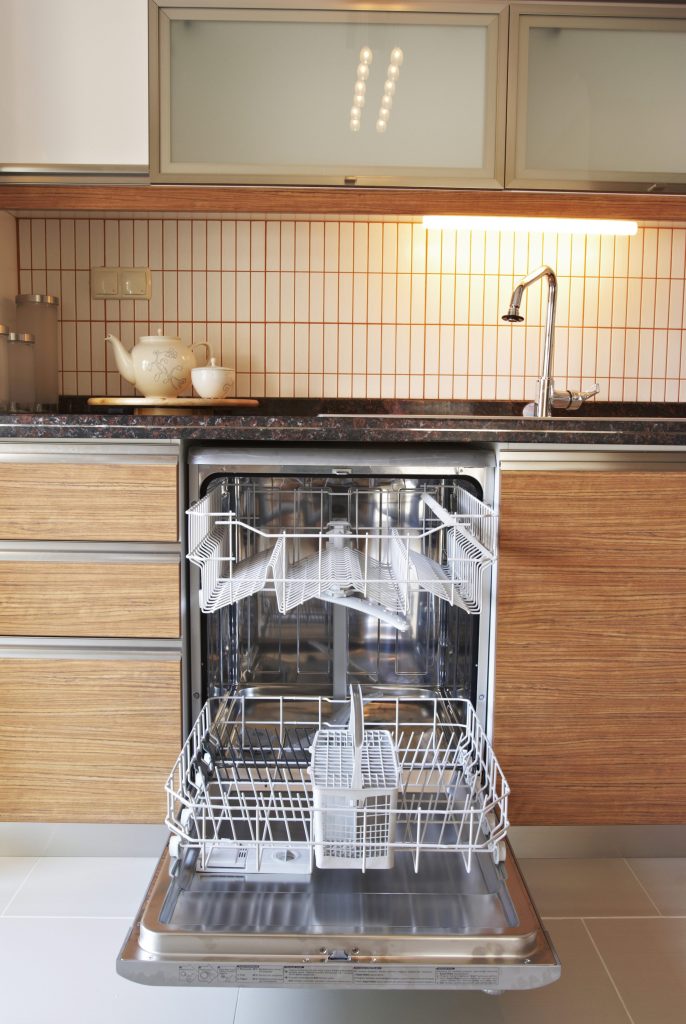 Open dishwasher in clean kitchen interior.