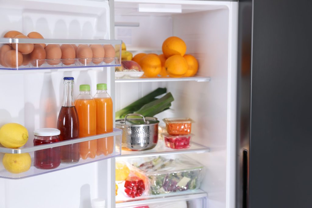 Organized refrigerator filled with fresh fruits.