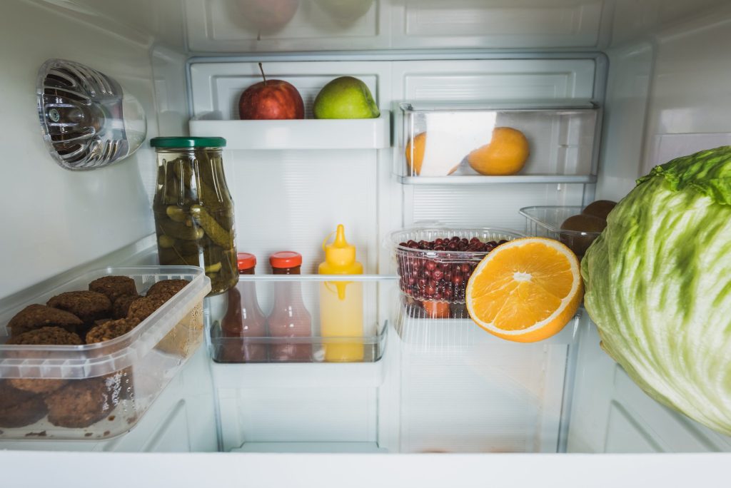Refrigerator interior filled with fresh food.