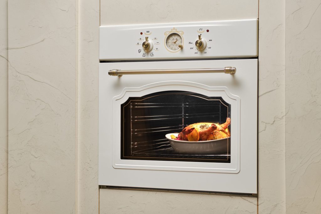 Roasted chicken prepared inside a white oven.