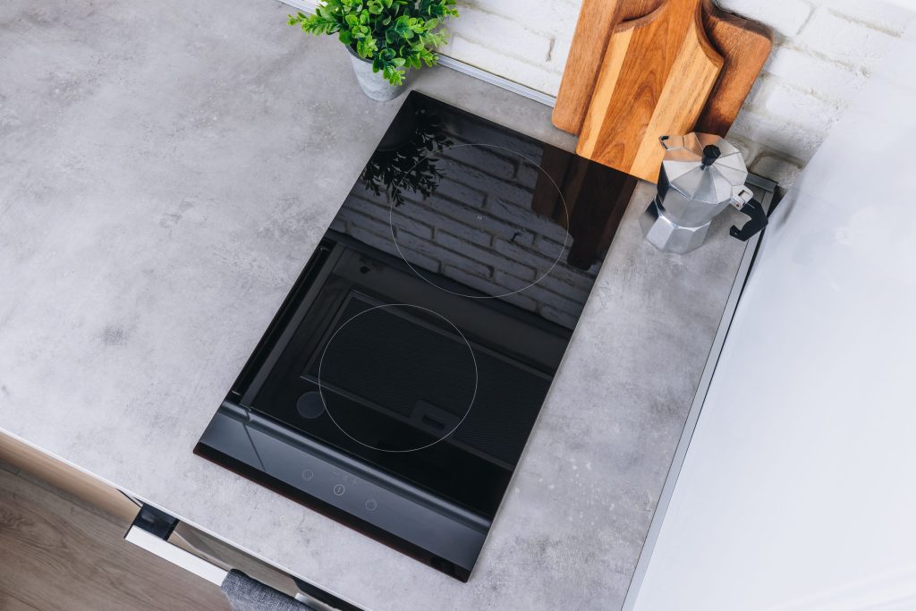 Sleek induction cooktop and kitchenware.