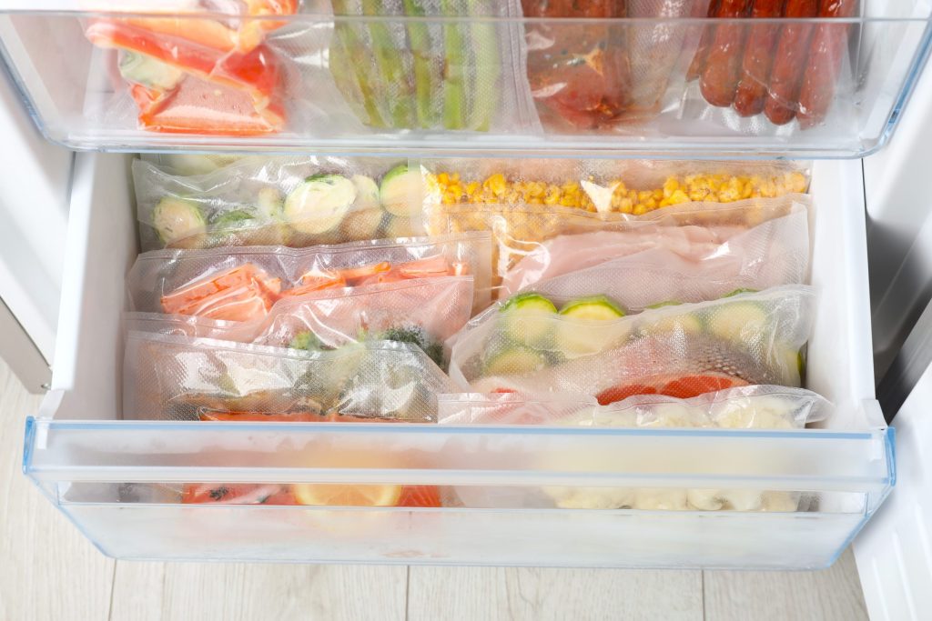 Vacuum bags with different products in fridge.