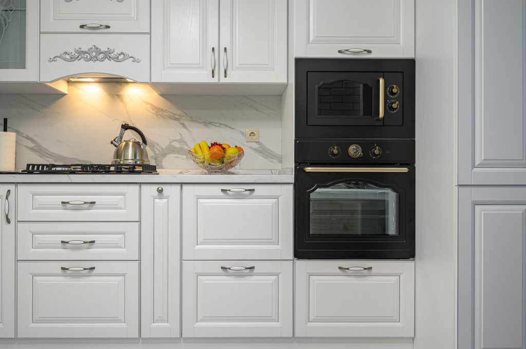 An oven in a white kitchen in classic style front view.