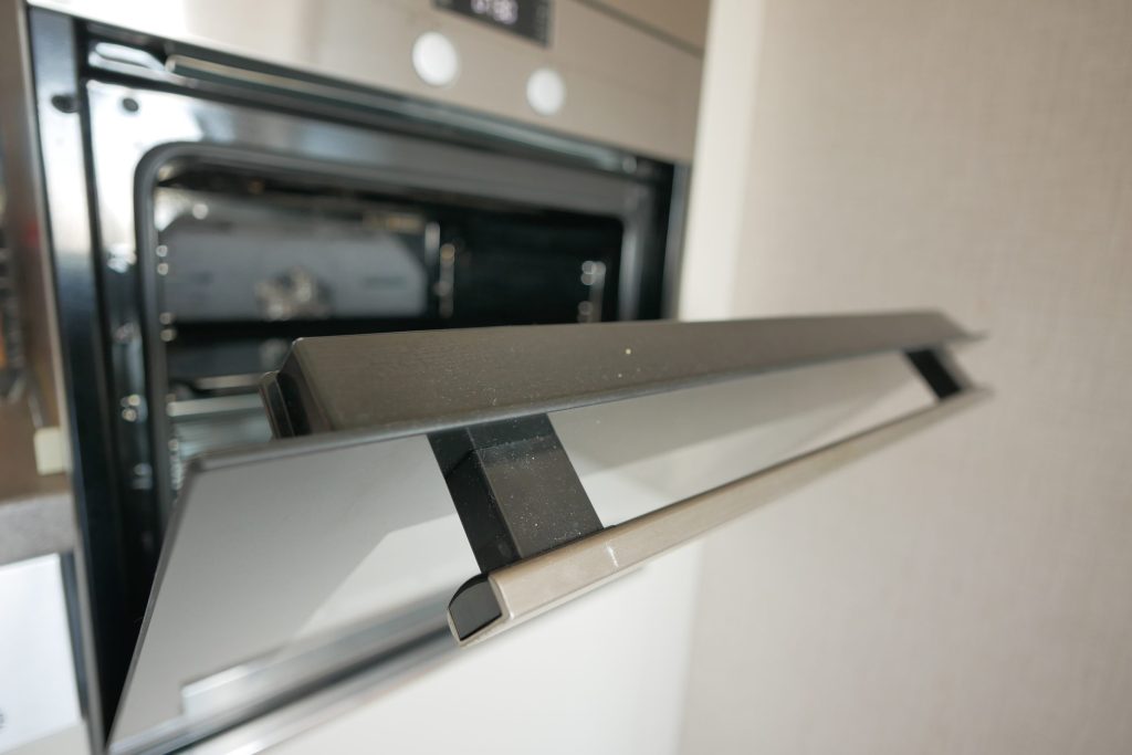 A built-in oven part open, seen along the handle.